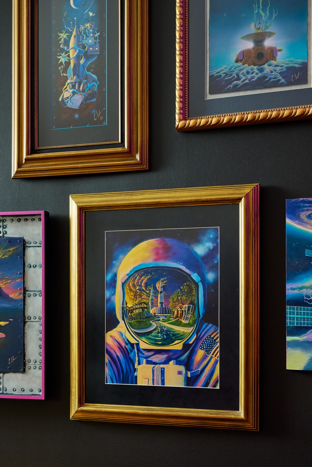 Astronaut painting in a gold frame