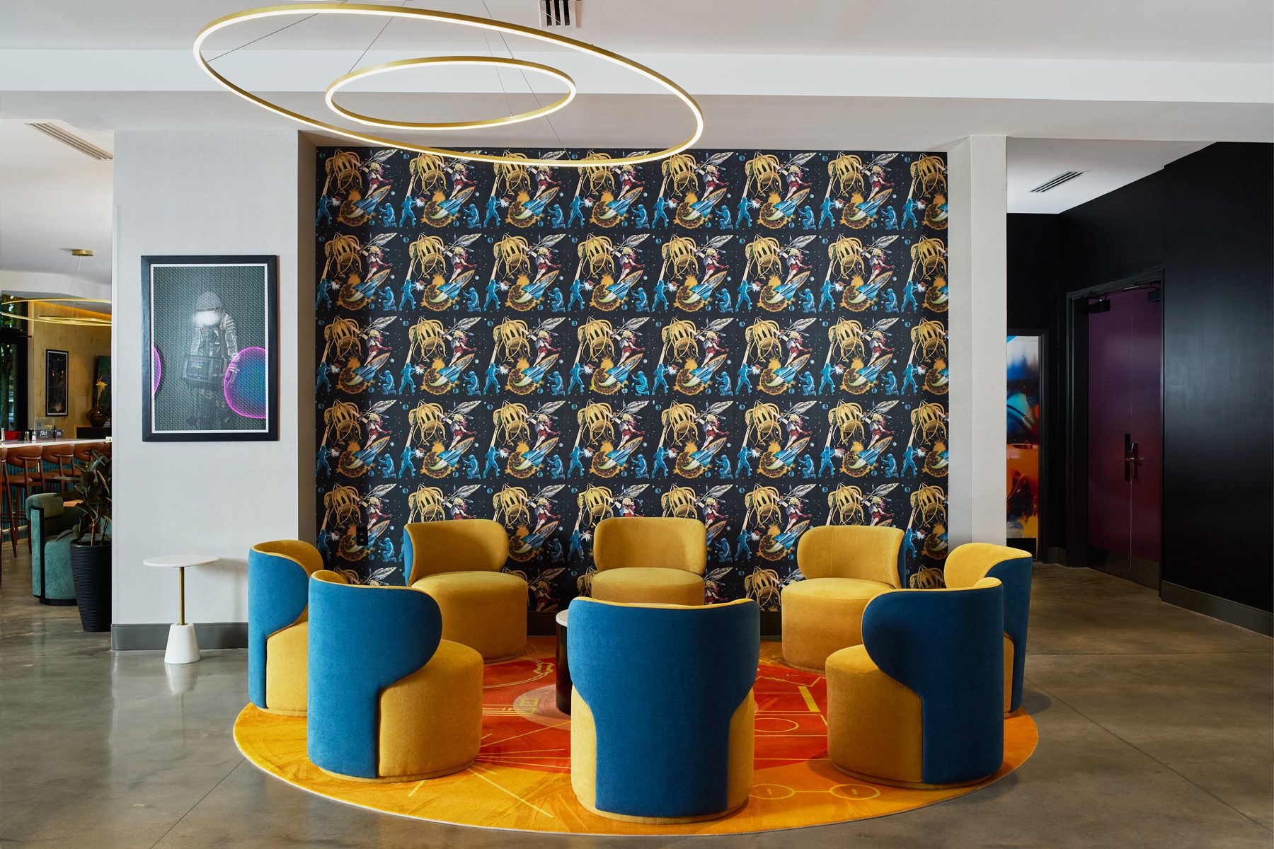 Lobby lounge with patterned wallpaper and mustard chairs