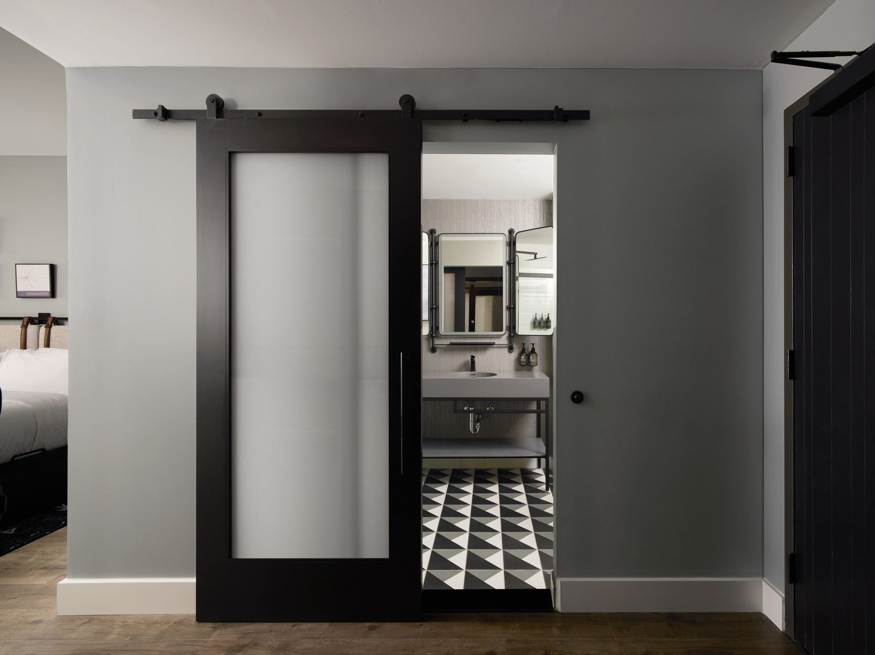 Sliding barn door to a suite bathroom