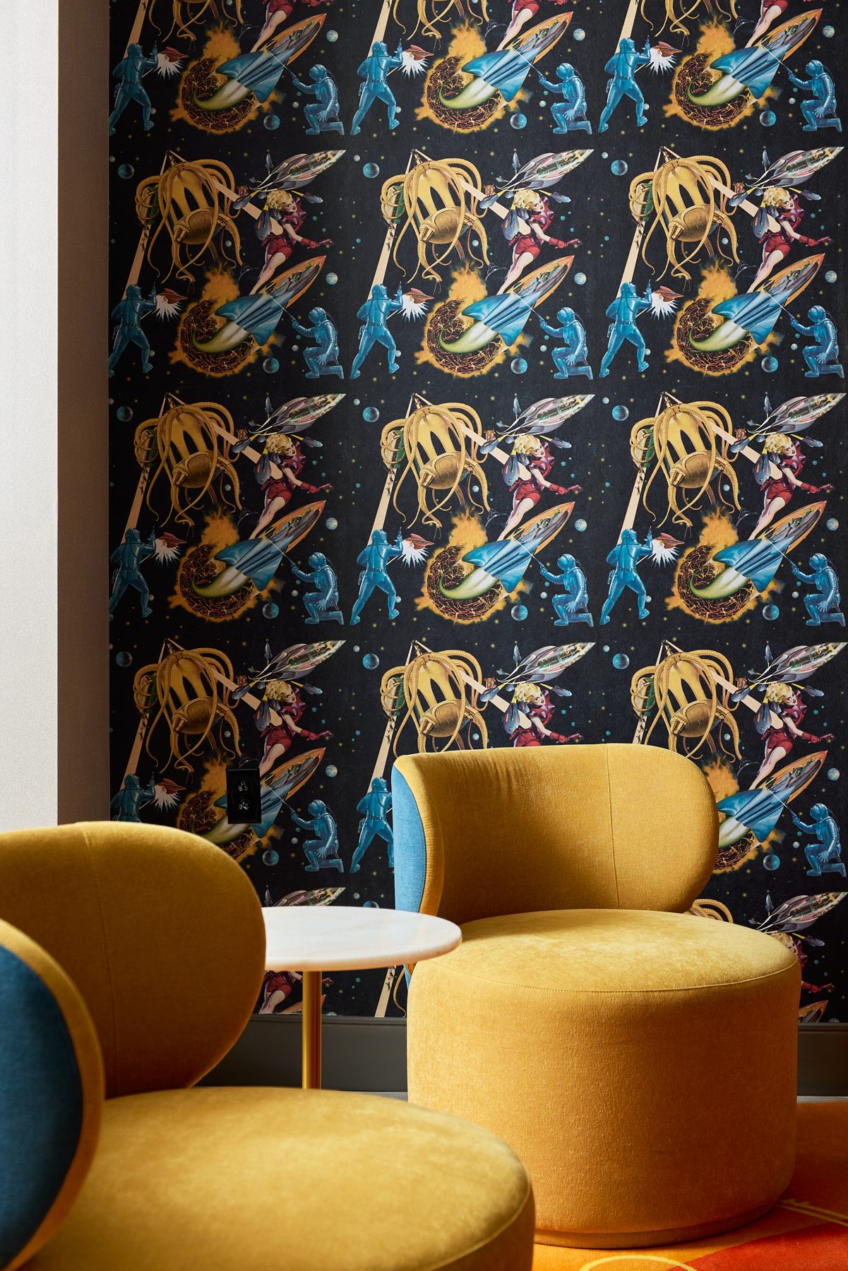Bold patterned wallpaper with a mustard chair